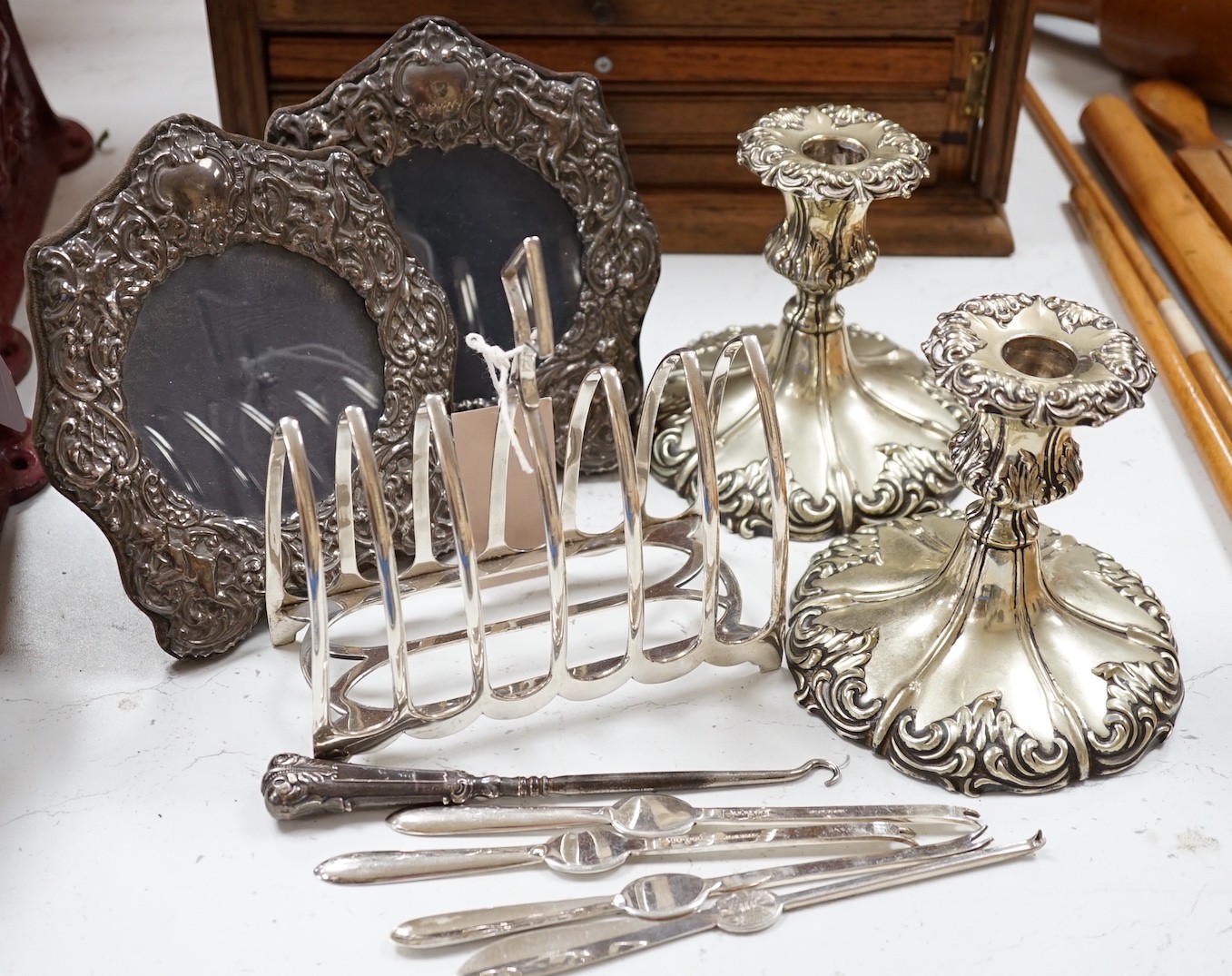 A pair of embossed silver photograph frames and plated wares